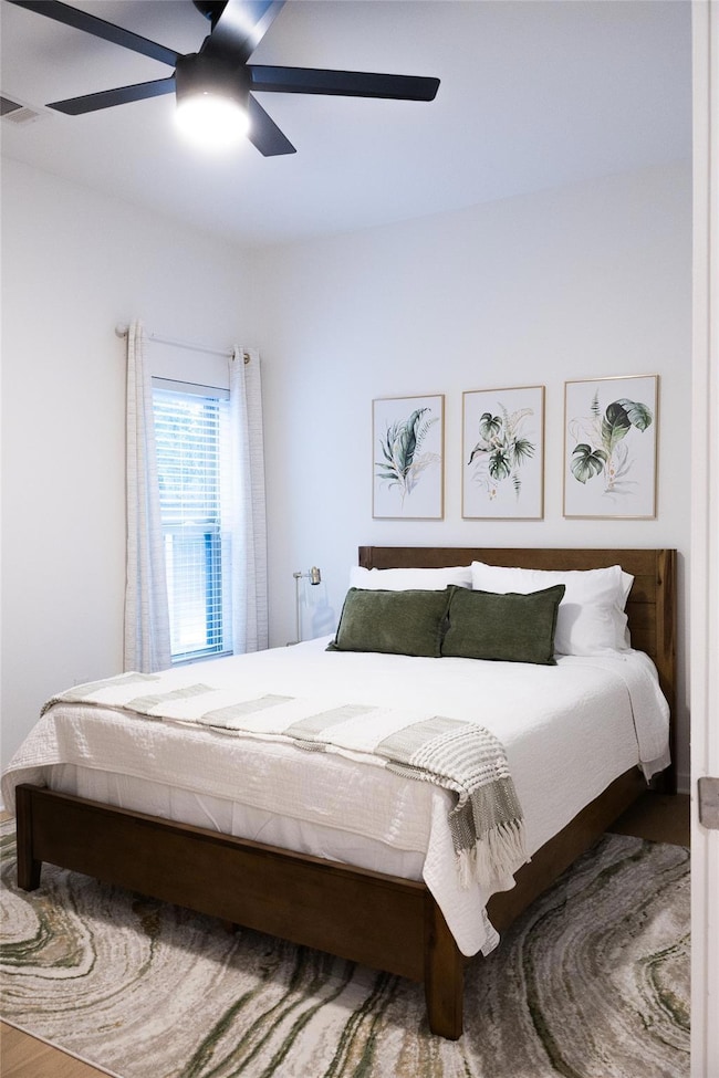 Bedroom featuring a ceiling fan and wood finished floors