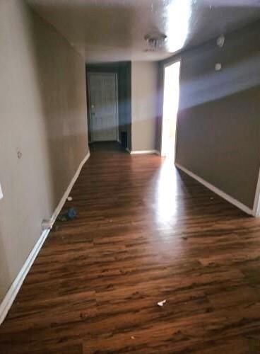 Spare room featuring dark hardwood / wood-style fl