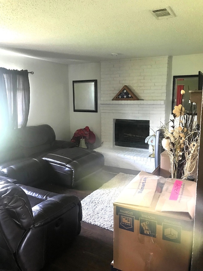 Living area with a brick fireplace