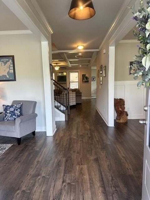 Hallway with wood finished floors and crown molding