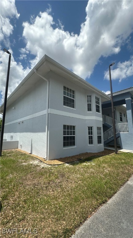 View of property exterior with stucco siding and a