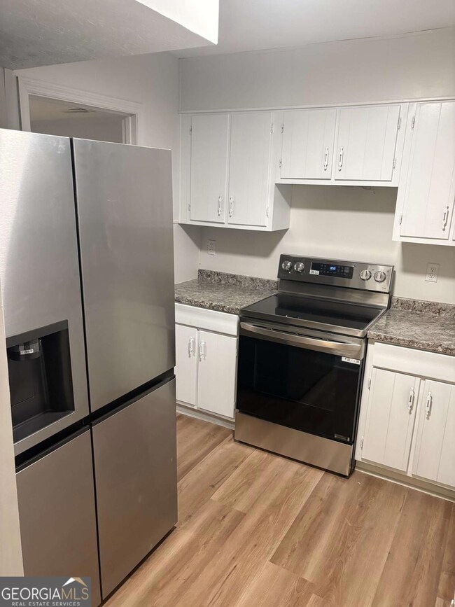 Lots of cabinets and new double sided refrigerator with ice and water maker