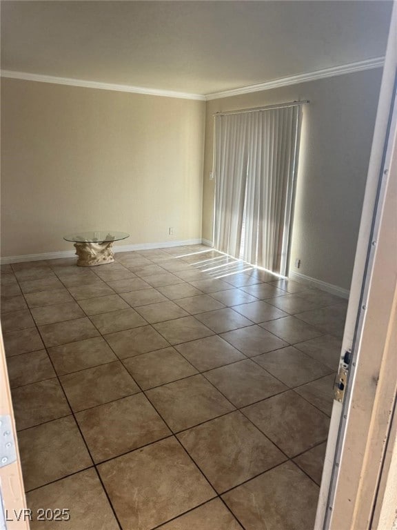 Spare room featuring crown molding, tile patterned