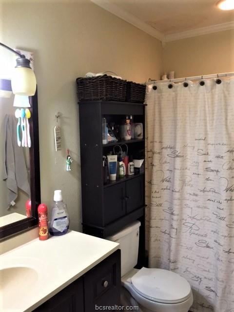 Bathroom featuring vanity, ornamental molding, cur