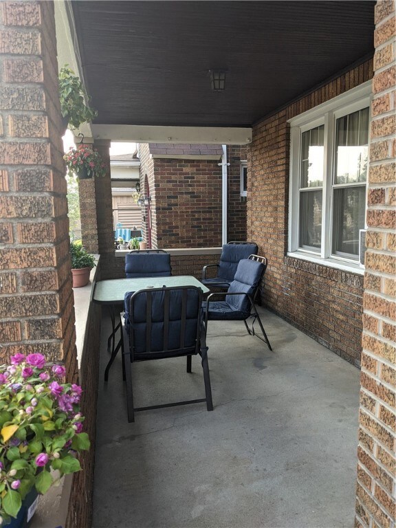 What a nice covered front porch to spend your summer days on!!