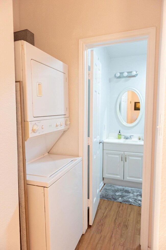 Laundry room with laundry area, stacked washer an