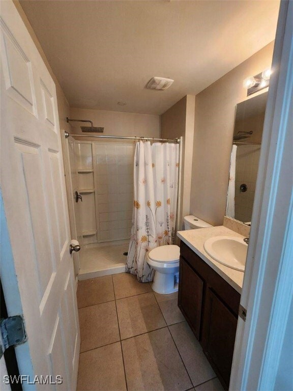 Bathroom featuring visible vents, tile patterned f