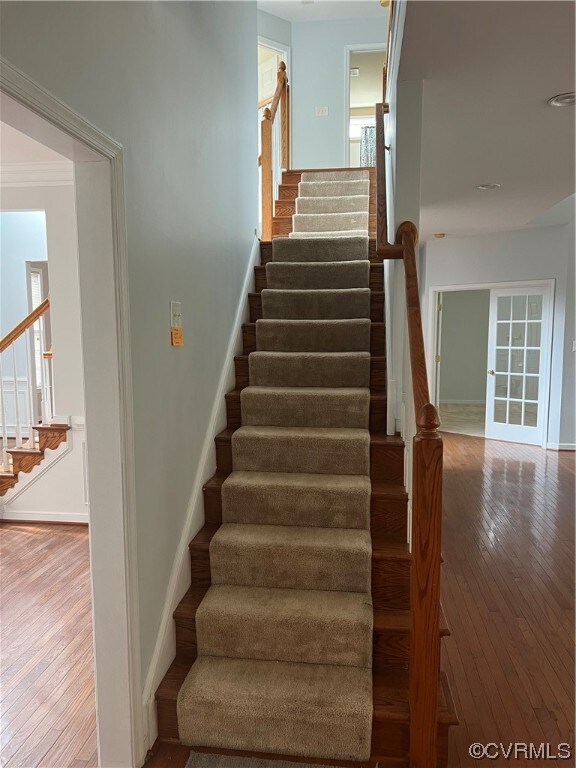 Stairs with light hardwood flooring