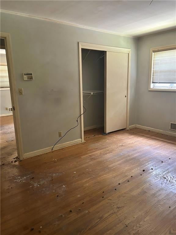 Unfurnished bedroom featuring a closet and wood finished floors