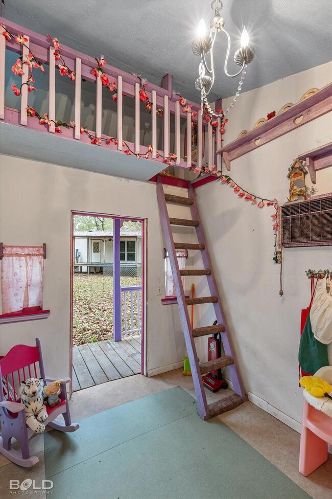 Bedroom featuring a chandelier and carpet