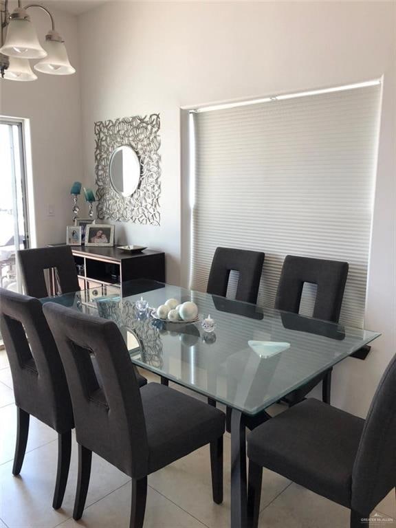 Dining space with light tile patterned floors