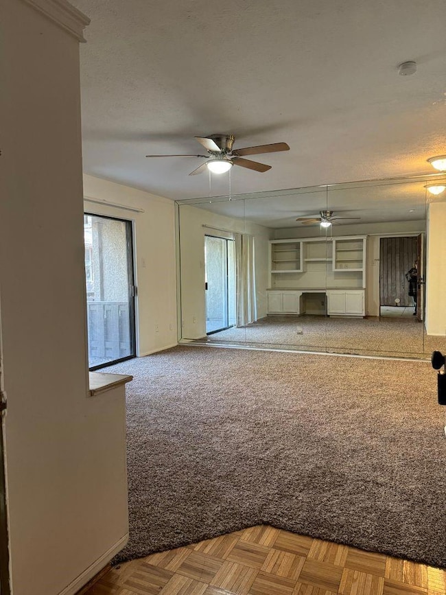 Unfurnished living room featuring carpet floors, c