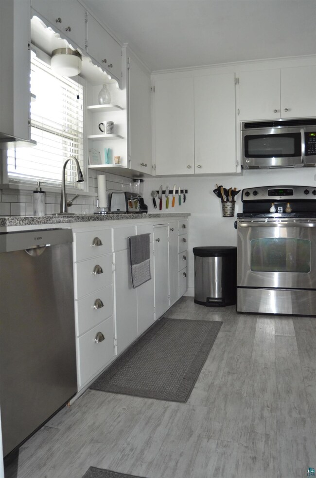 Kitchen featuring stainless steel appliances, whit