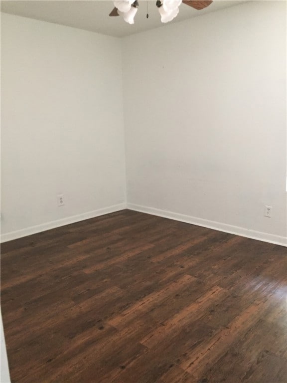 Unfurnished room with dark hardwood / wood-style f