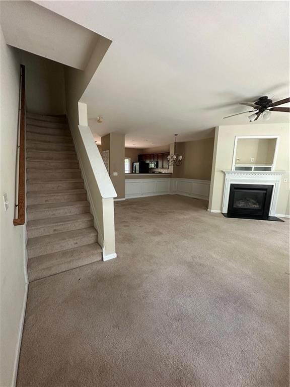 Unfurnished living room featuring a ceiling fan, s