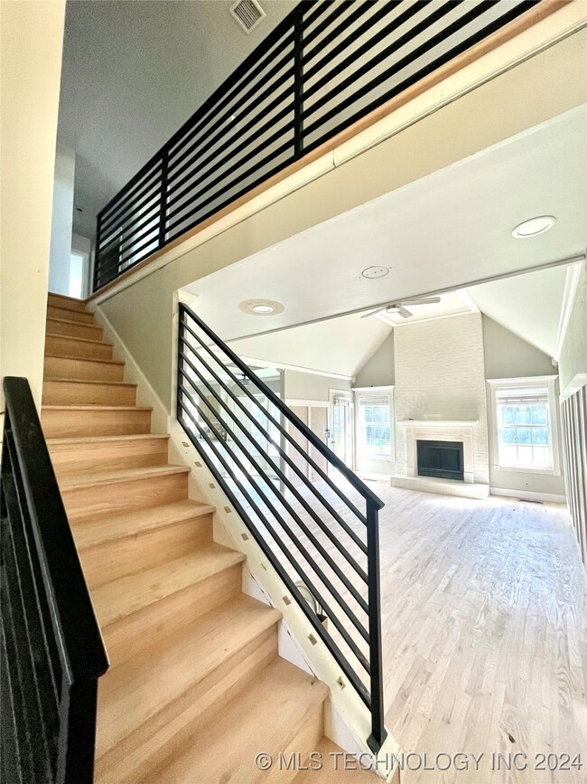 Iron railing stairs leading upstairs and living ro