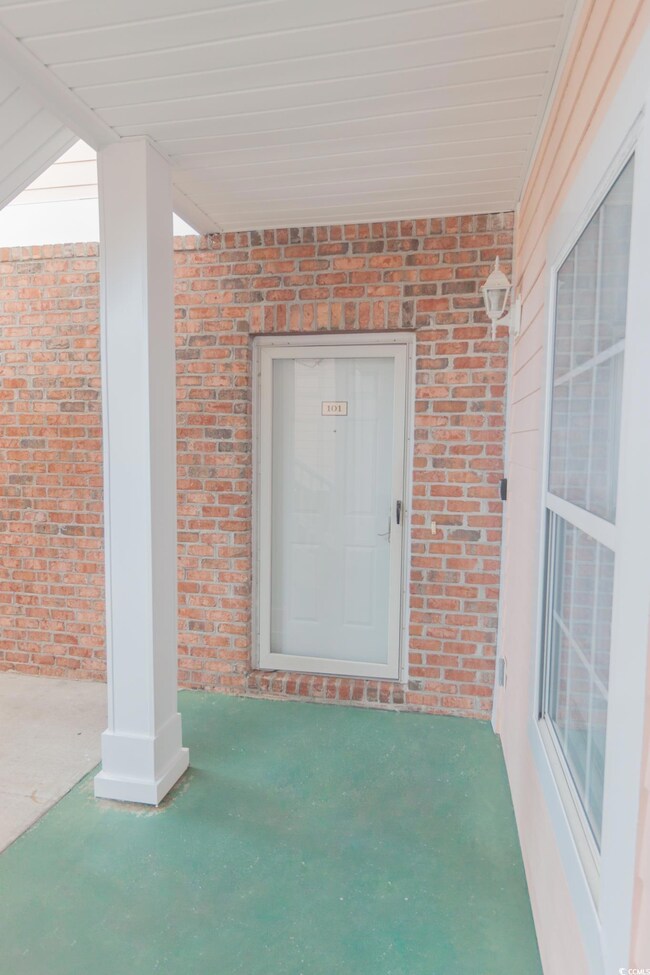 Doorway to property with brick siding