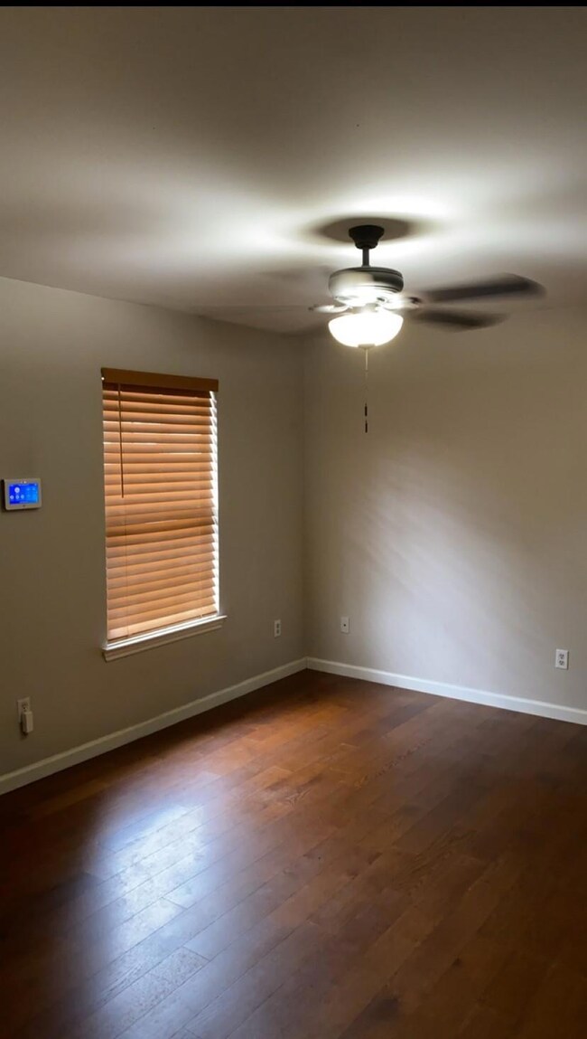 Empty room with dark hardwood / wood-style floors 