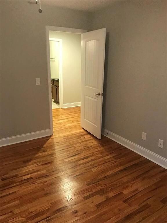 Empty room with light wood-style floors and baseboards