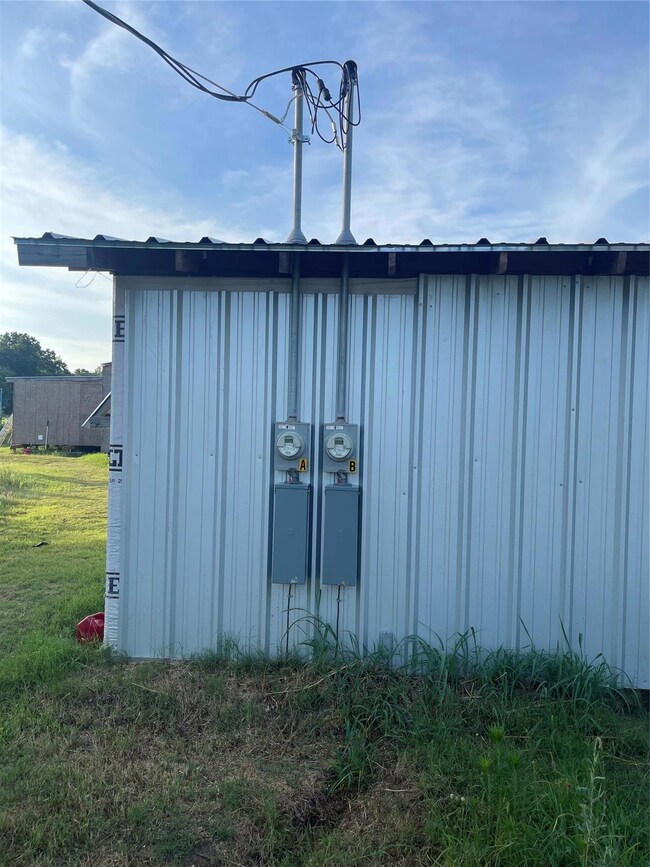 View of outdoor structure with a yard