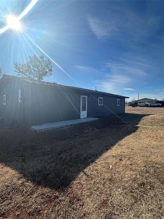 Rear view of property with a lawn