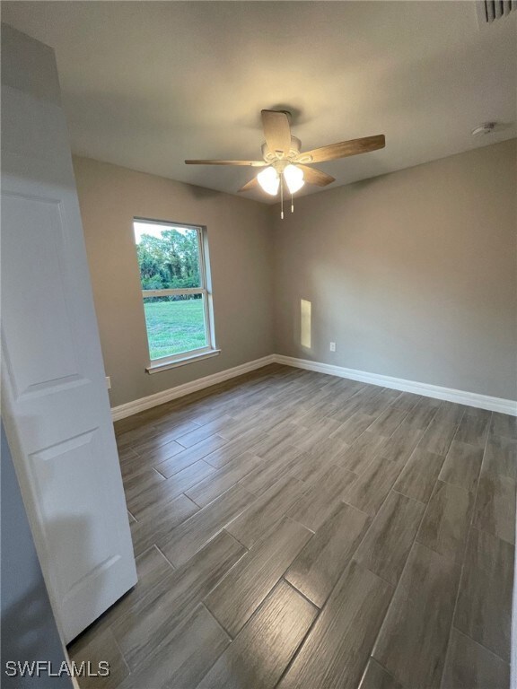 Unfurnished room with hardwood / wood-style floors