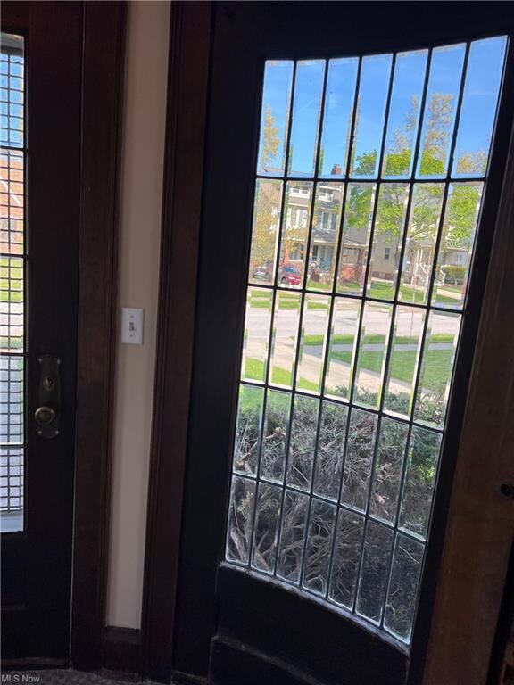 Full length windows to right & left of door in foyer