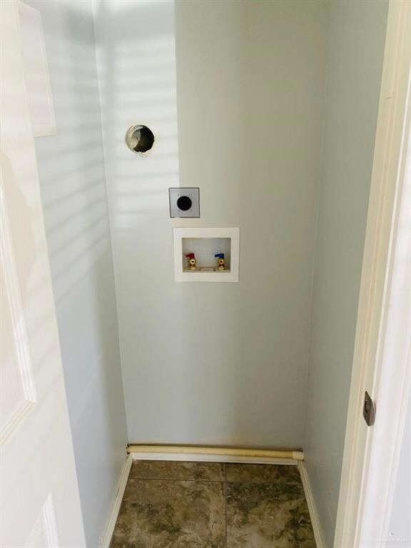 Washroom with washer hookup, baseboards, and hookup for an electric dryer
