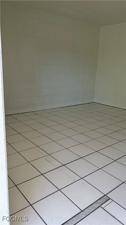 Empty room with light tile patterned floors