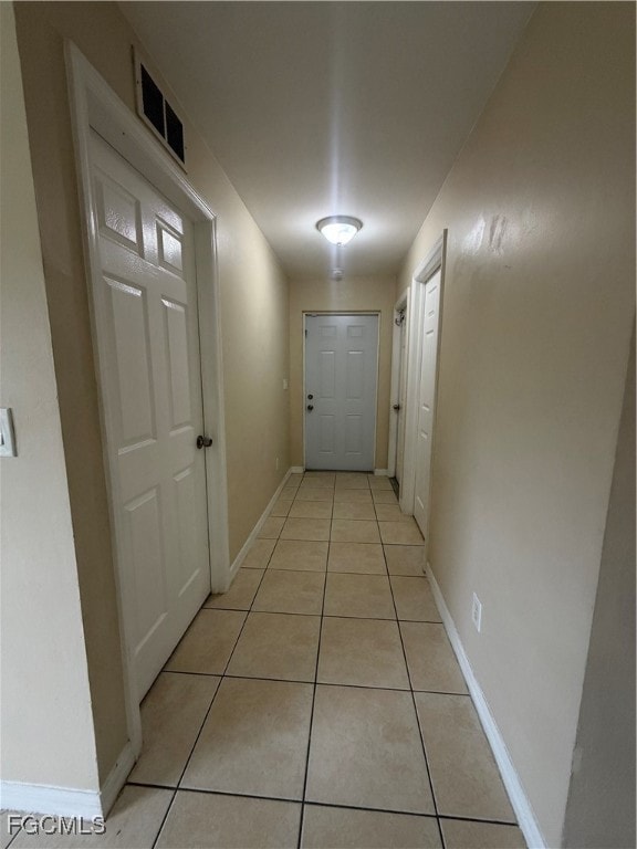 Hall with light tile patterned floors