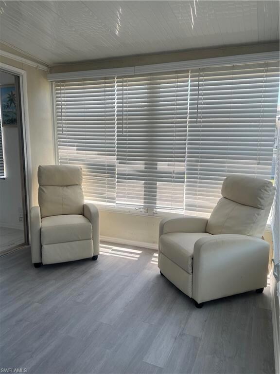 Sitting room featuring baseboards and wood finishe