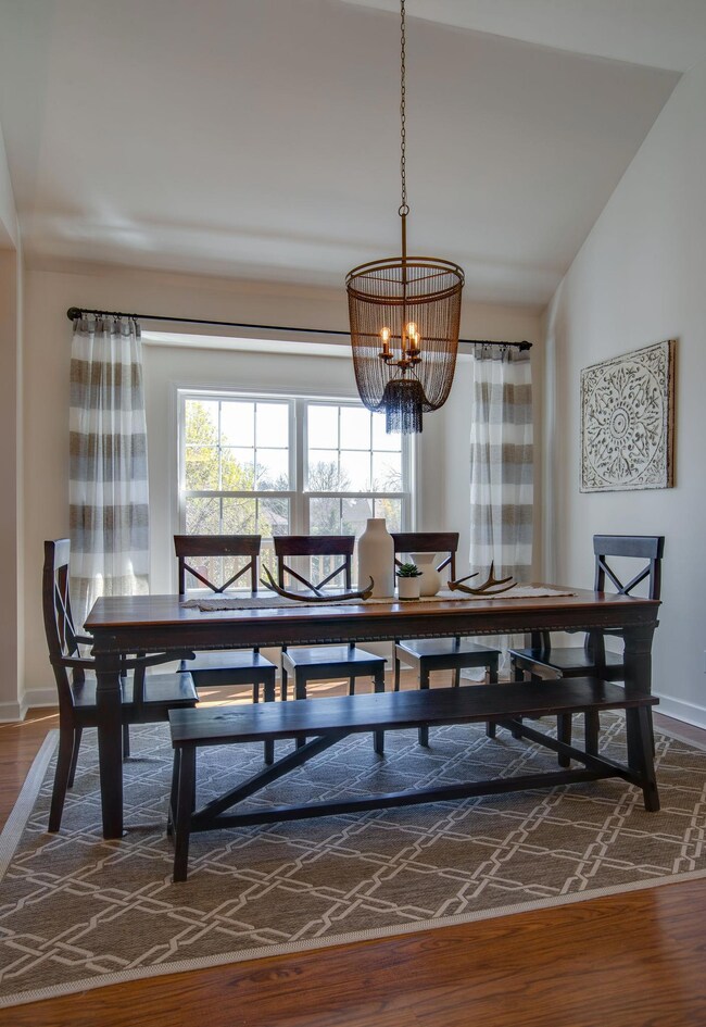 A Pottery Barn Chainmail Chandelier is Gorgeous in this Light Filled Dining Room! A Vaulted Ceiling Opens this Space as well! This Home is Perfect for Entertaining!