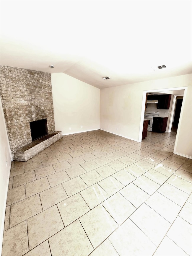 Unfurnished living room with lofted ceiling, a br