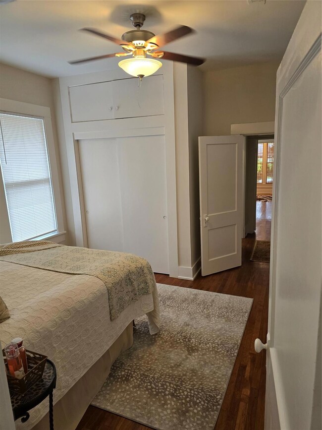 Bedroom featuring ceiling fan and dark hardwood / 