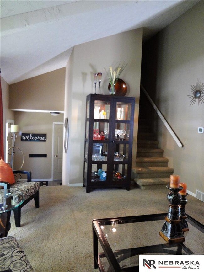 Main floor living room with cathedral ceiling.