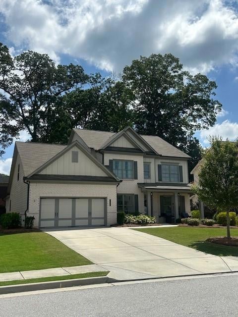 Craftsman-style house featuring a garage, brick siding, concrete driveway, and a front yard