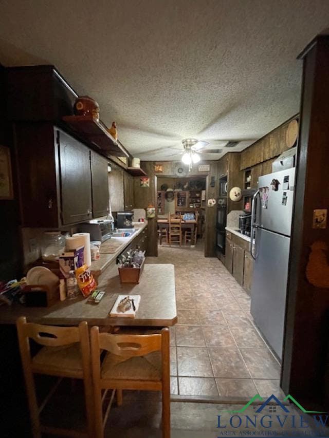 Kitchen with light countertops, a ceiling fan, fre