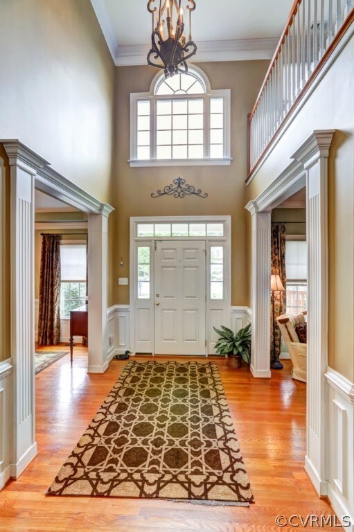 Two story foyer with gleaming hardwood floors, sha