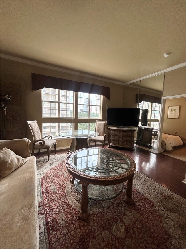 Living room featuring crown molding and wood finished floors