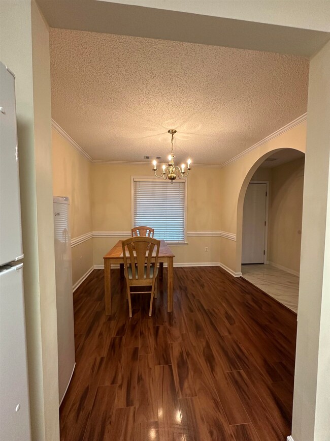Dining space featuring dark wood-type flooring, or