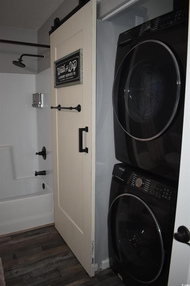 Clothes washing area featuring stacked washing mac