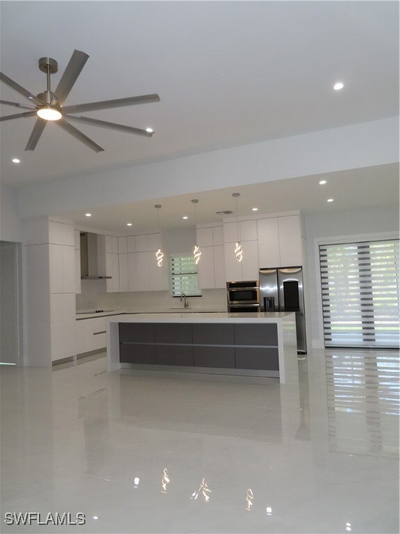 Kitchen featuring modern cabinets, range hood, whi