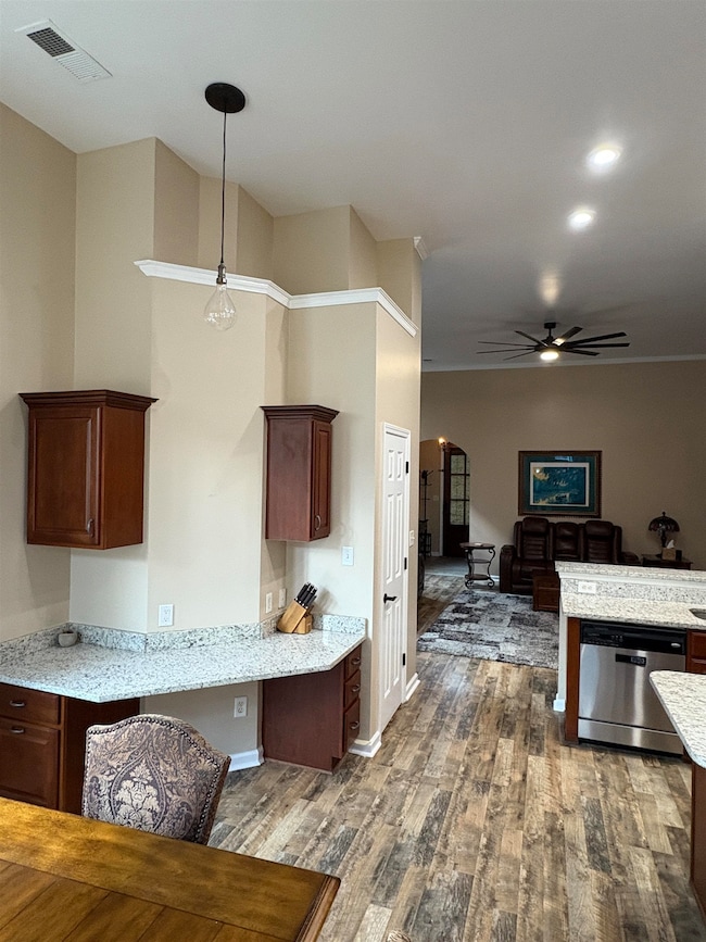 Kitchen featuring arched walkways, stainless steel