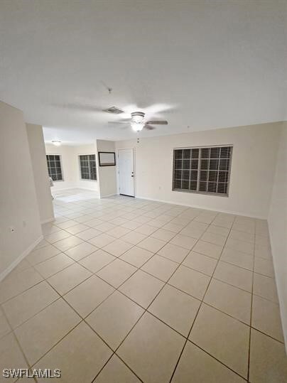Spare room with light tile patterned floors, a cei