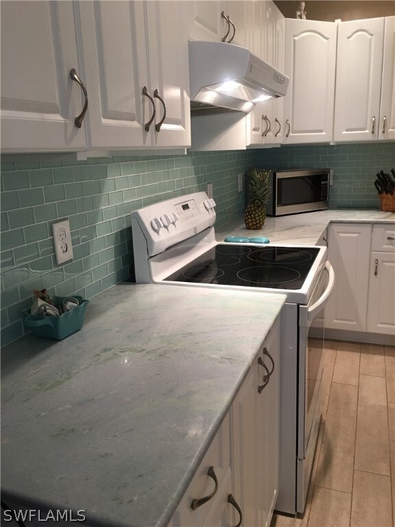 Marble kitchen counter tops, tile backsplash and tile floors