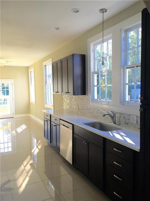 Bright kitchen with solid wood cabinets, glass mos