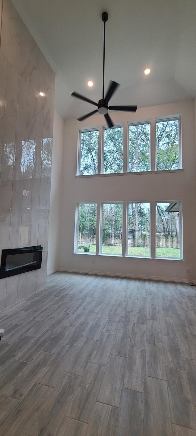 View of family room with ample amount of windows to let natural light in and enjoy the view of your back yard oasis.