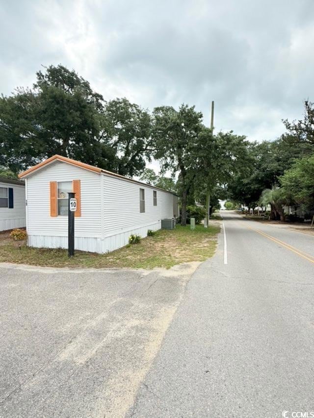 View of side of property with central AC