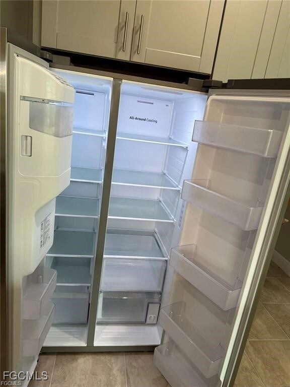 Kitchen view of stainless steel refrigerator