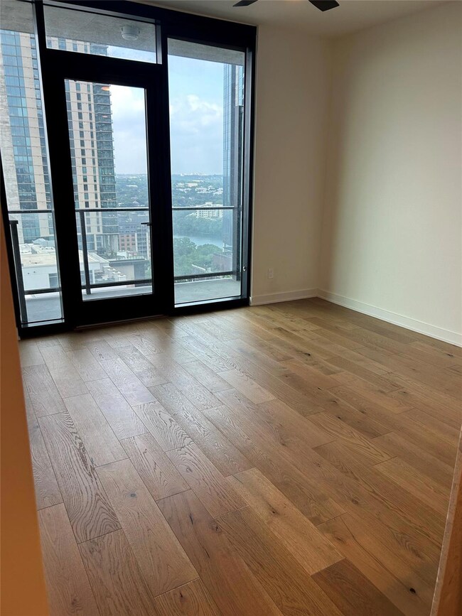 Spare room with baseboards, ceiling fan, hardwood